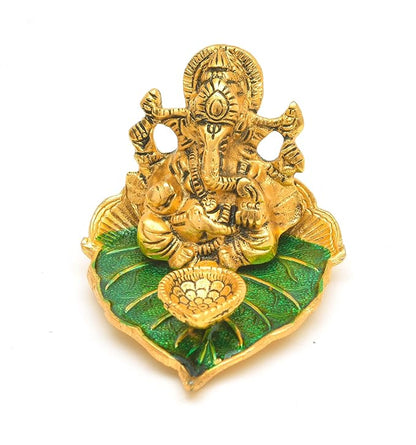 Elite Brass Metal Ganesh Ji Sitting on The Green Leave with Diya Deepak , Golden Decorative Showpiece - 9 cm  (Brass, Gold)