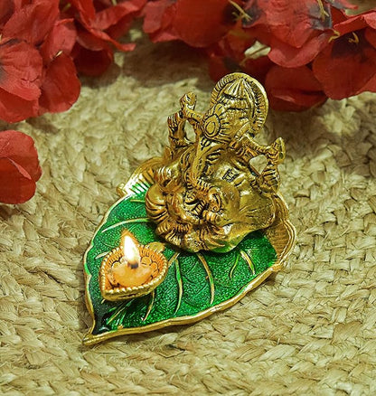 Elite Brass Metal Ganesh Ji Sitting on The Green Leave with Diya Deepak , Golden Decorative Showpiece - 9 cm  (Brass, Gold)