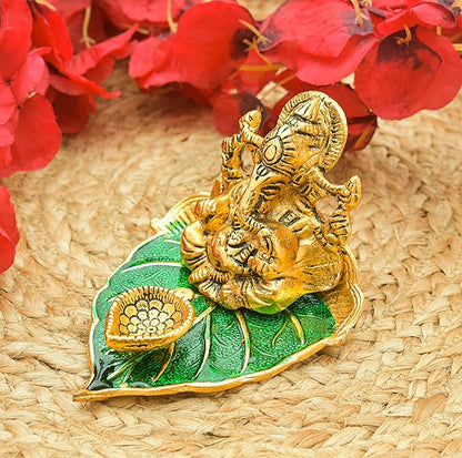 Elite Brass Metal Ganesh Ji Sitting on The Green Leave with Diya Deepak , Golden Decorative Showpiece - 9 cm  (Brass, Gold)